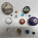 A variety of balls, marbles, and dice